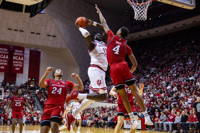 Jan 2, 2025; Bloomington, Indiana, USA; Indiana Hoosiers center Oumar Ballo (11) shoots the ball while Rutgers Scarlet Knights guard Ace Bailey (4) defends in the first half at Simon Skjodt Assembly Hall. Mandatory Credit: Trevor Ruszkowski-Imagn Images