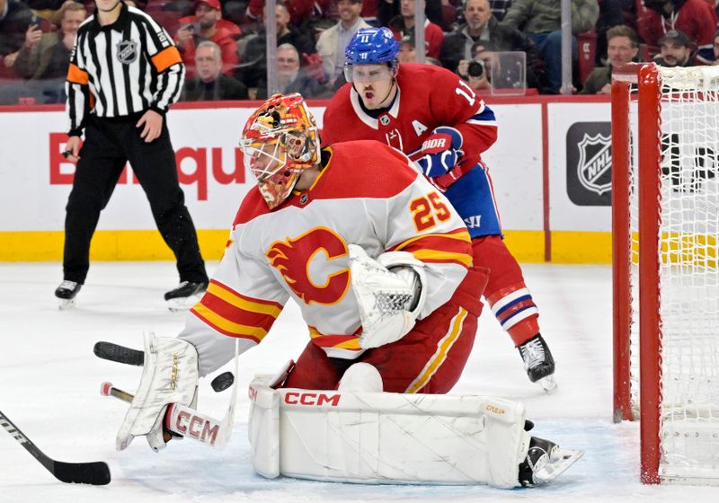 Nov 14, 2023; Montreal, Quebec, CAN; Calgary Flames goalie Jacob Markstrom (25) makes a save and Montreal Canadiens forward Brendan Gallagher (11) looks on during the third period at the Bell Centre. Mandatory Credit: Eric Bolte-USA TODAY Sports