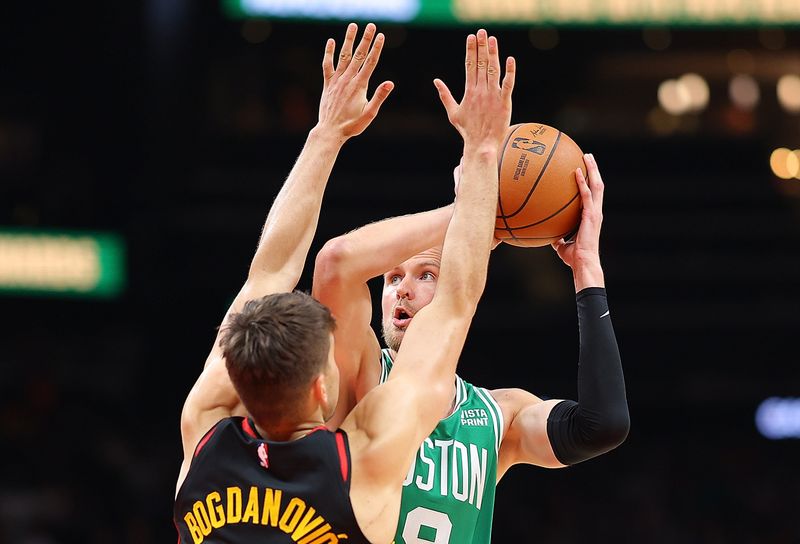 ATLANTA, GEORGIA - MARCH 28:  Bogdan Bogdanovic #13 of the Atlanta Hawks defends against Kristaps Porzingis #8 of the Boston Celtics during the second quarter at State Farm Arena on March 28, 2024 in Atlanta, Georgia.  NOTE TO USER: User expressly acknowledges and agrees that, by downloading and/or using this photograph, user is consenting to the terms and conditions of the Getty Images License Agreement.  (Photo by Kevin C. Cox/Getty Images)