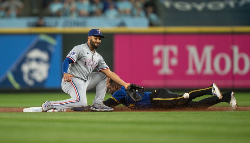 Sep 13, 2024; Seattle, Washington, USA;  Seattle Mariners right fielder Victor Robles (10) steals second base in front of Texas Rangers second baseman Marcus Semien (2)  during the first inning at T-Mobile Park. Mandatory Credit: Stephen Brashear-Imagn Images