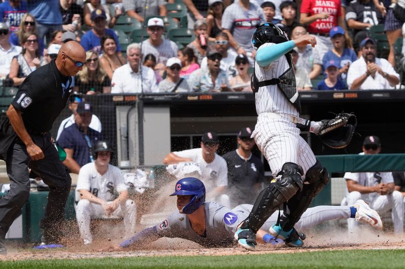 Jul 27, 2025; Chicago, Illinois, USA; Chicago Cubs second base Nico Hoerner (2) is safe at home plate as Chicago White Sox catcher Edgar Quero (7) takes a late throw during the sixth inning at Rate Field. Mandatory Credit: David Banks-Imagn Images
