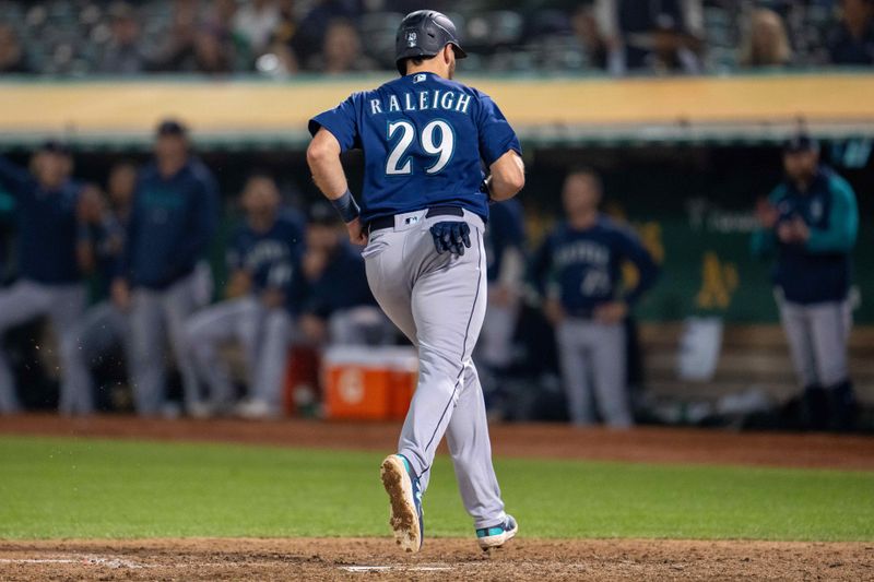 Sep 19, 2023; Oakland, California, USA; Seattle Mariners catcher Cal Raleigh (29) scores on a wild pitch by Oakland Athletics relief pitcher Easton Lucas (not pictured) during the seventh inning at Oakland-Alameda County Coliseum. Mandatory Credit: Neville E. Guard-USA TODAY Sports