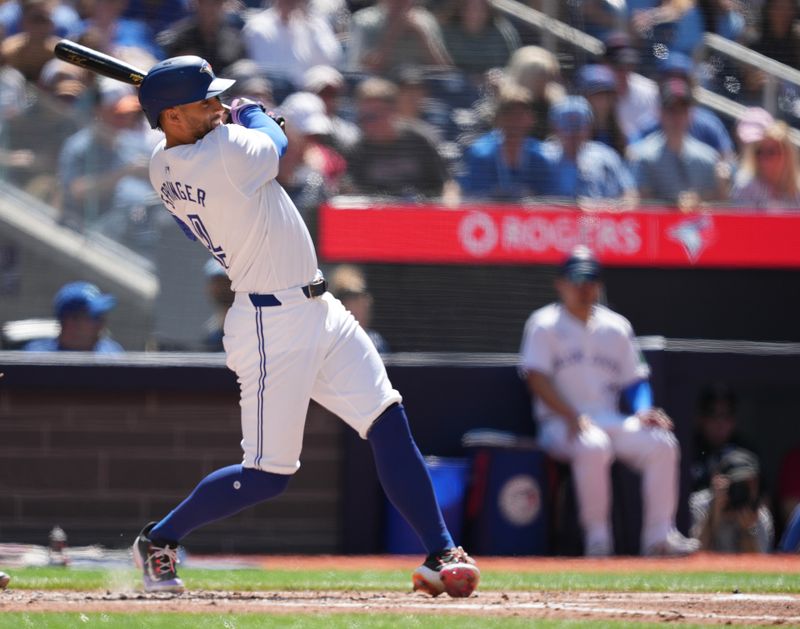 Jun 15, 2024; Toronto, Ontario, CAN; Toronto Blue Jays right fielder George Springer (4) hits an RBI single against the Cleveland Guardians during the second inning at Rogers Centre. Mandatory Credit: Nick Turchiaro-USA TODAY Sports