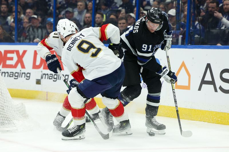 Feb 17, 2024; Tampa, Florida, USA;  Tampa Bay Lightning center Steven Stamkos (91) controls the puck  from Florida Panthers center Sam Bennett (9) in the first period at Amalie Arena. Mandatory Credit: Nathan Ray Seebeck-USA TODAY Sports