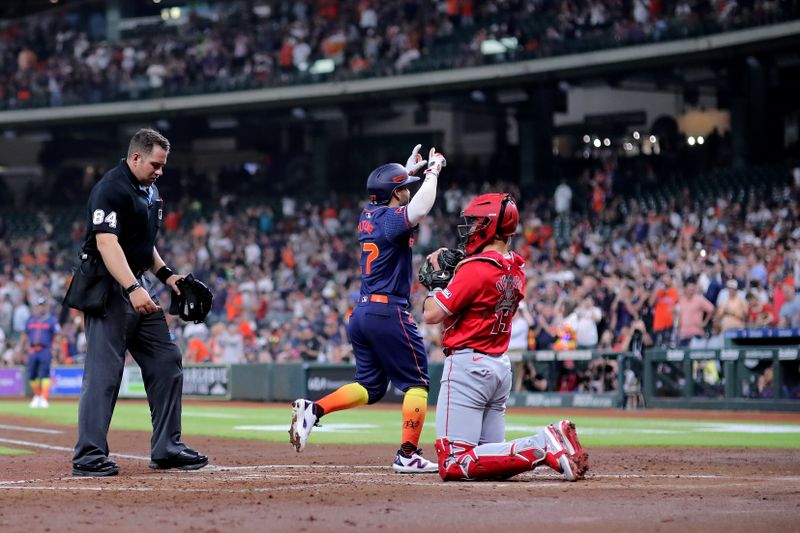 May 20, 2024; Houston, Texas, USA; Houston Astros second baseman Jose Altuve (27) crosses home plate after hitting a three-run home run to left field against the Los Angeles Angels during the second inning at Minute Maid Park. Mandatory Credit: Erik Williams-USA TODAY Sports