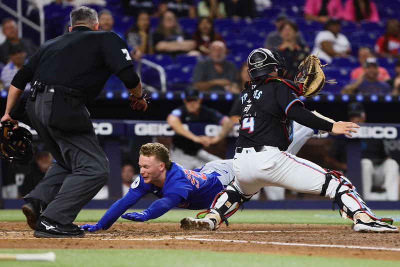 Aug 23, 2024; Miami, Florida, USA; Chicago Cubs center fielder Pete Crow-Armstrong (52) dives at home plate and scores against Miami Marlins catcher Nick Fortes (4) after hitting an inside-the-park home run during the third inning at loanDepot Park. Mandatory Credit: Sam Navarro-USA TODAY Sports