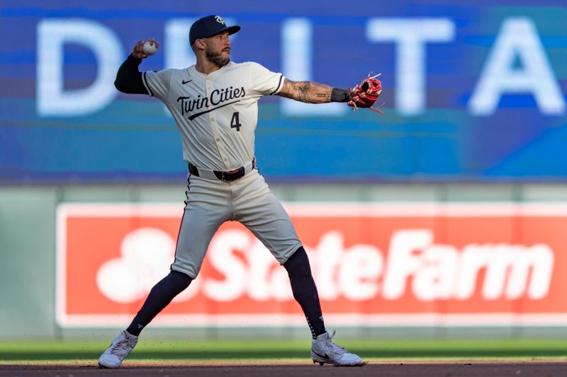 Jun 11, 2024; Minneapolis, Minnesota, USA; Minnesota Twins shortstop Carlos Correa (4) throws the ball to first base for an out against the Colorado Rockies in the second inning at Target Field. Mandatory Credit: Jesse Johnson-USA TODAY Sports