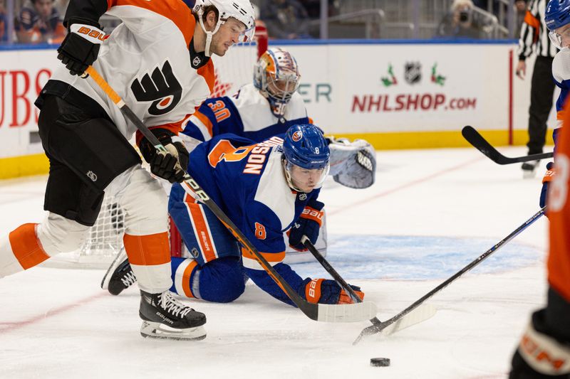 Nov 25, 2023; Elmont, New York, USA; New York Islanders defenseman Noah Dobson (8) dives for the puck while in front of the goal against the Philadelphia Flyers during the third period at UBS Arena. Mandatory Credit: Thomas Salus-USA TODAY Sports