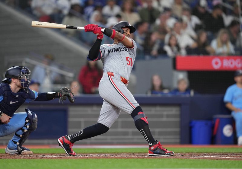 May 11, 2024; Toronto, Ontario, CAN; Minnesota Twins centre fielder Willi Castro (50) hits a double against the Toronto Blue Jays during the third inning at Rogers Centre. Mandatory Credit: Nick Turchiaro-USA TODAY Sports