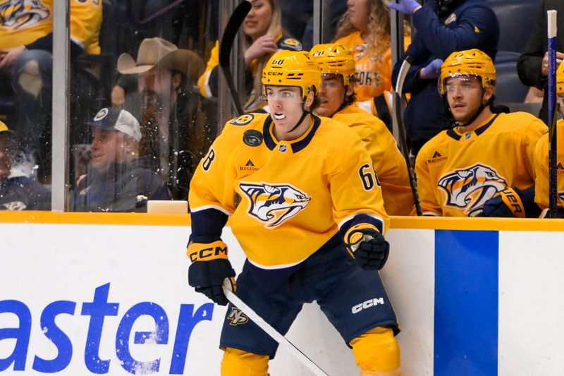 Jan 29, 2025; Nashville, Tennessee, USA;  Nashville Predators left wing Zachary L'Heureux (68) grabs the puck from the air against the Vancouver Canucks during the first period at Bridgestone Arena. Mandatory Credit: Steve Roberts-Imagn Images
