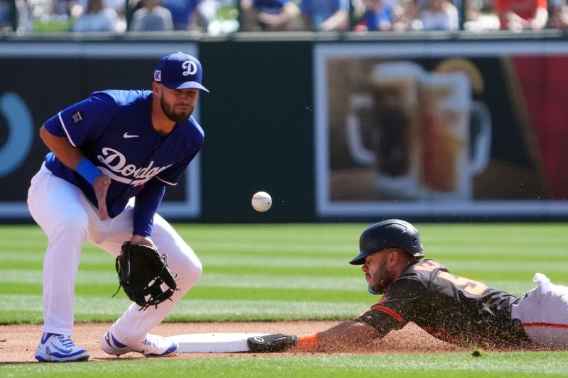 Mar 1, 2025; Phoenix, Arizona, USA; San Francisco Giants outfielder Grant McCray (58) beats a throw to Los Angeles Dodgers second baseman David Bote (12) to steal second base, during the first inning at Camelback Ranch-Glendale. Mandatory Credit: Joe Camporeale-Imagn Images