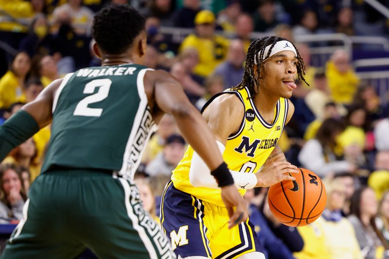 Feb 18, 2023; Ann Arbor, Michigan, USA;  Michigan Wolverines guard Dug McDaniel (0) controls the ball against Michigan State Spartans guard Tyson Walker (2) in the first half at Crisler Center. Mandatory Credit: Rick Osentoski-USA TODAY Sports