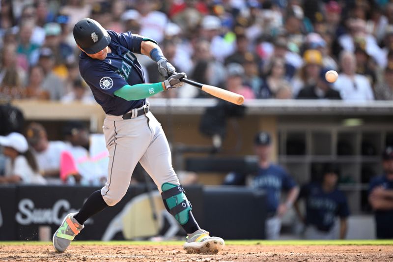 Jul 10, 2024; San Diego, California, USA; Seattle Mariners left fielder Dylan Moore (25) hits a single against the San Diego Padres during the seventh inning at Petco Park. Mandatory Credit: Orlando Ramirez-USA TODAY Sports