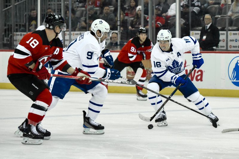 Apr 9, 2024; Newark, New Jersey, USA; Toronto Maple Leafs right wing Mitch Marner (16) skates with the puck while being defended by New Jersey Devils left wing Ondrej Palat (18) during the first period at Prudential Center. Mandatory Credit: John Jones-USA TODAY Sports