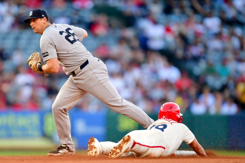 May 27, 2025; Anaheim, California, USA; Los Angeles Angels first baseman Nolan Schanuel (18) is out at second as New York Yankees second baseman DJ LeMahieu (26) is late on the throw to first during the first inning at Angel Stadium. Mandatory Credit: Gary A. Vasquez-Imagn Images