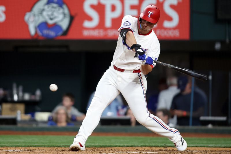 Jun 18, 2024; Arlington, Texas, USA; Texas Rangers shortstop Corey Seager (5) singles in a run in th fifth inning against the New York Mets at Globe Life Field. Mandatory Credit: Tim Heitman-USA TODAY Sports