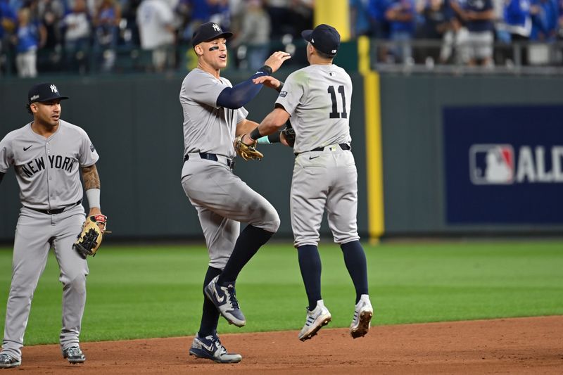 Oct 9, 2024; Kansas City, Missouri, USA; New York Yankees outfielder Aaron Judge (99) celebrates with shortstop Anthony Volpe (11) after defeating the Kansas City Royals during game three of the NLDS for the 2024 MLB Playoffs at Kauffman Stadium. Mandatory Credit: Peter Aiken-Imagn Images