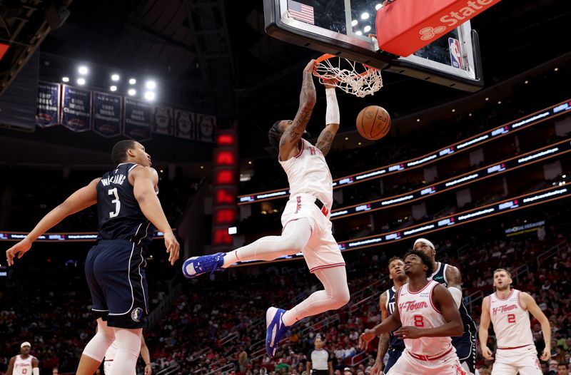 HOUSTON, TEXAS - DECEMBER 22: Cam Whitmore #7 of the Houston Rockets dunks the ball in the second half against the Dallas Mavericks at Toyota Center on December 22, 2023 in Houston, Texas.   NOTE TO USER: User expressly acknowledges and agrees that, by downloading and or using this photograph, User is consenting to the terms and conditions of the Getty Images License Agreement. (Photo by Tim Warner/Getty Images)