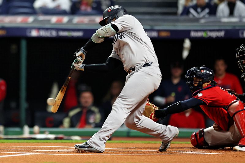 Oct 19, 2024; Cleveland, Ohio, USA; New York Yankees second base Gleyber Torres (25) hits a single during the first inning against the Cleveland Guardians during game five of the ALCS for the 2024 MLB playoffs at Progressive Field. Mandatory Credit: Scott Galvin-Imagn Images