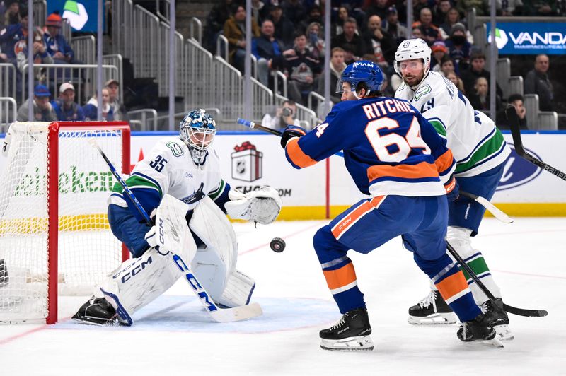 Dec 19, 2025; Elmont, New York, USA; Vancouver Canucks goaltender Thatcher Demko (35) makes a save against the New York Islanders during the second period at UBS Arena. Mandatory Credit: John Jones-Imagn Images