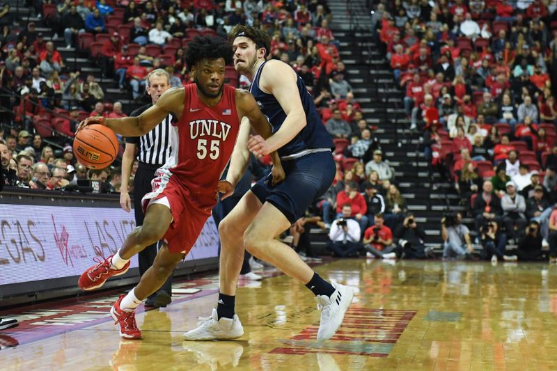 Jan 28, 2023; Las Vegas, Nevada, USA; UNLV Runnin' Rebels guard EJ Harkless (55) dribbles around Nevada Wolf Pack center Will Baker (50) in the second half at Thomas & Mack Center. Mandatory Credit: Candice Ward-USA TODAY Sports