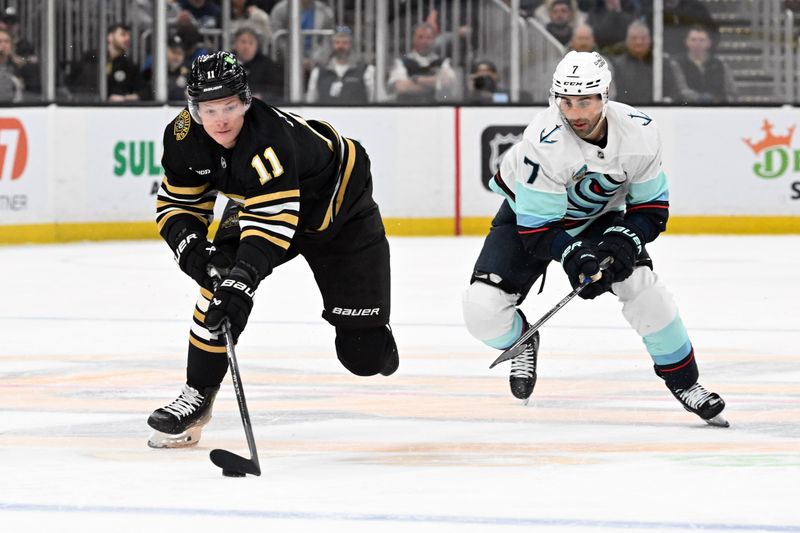 Feb 15, 2024; Boston, Massachusetts, USA; Boston Bruins center Trent Frederic (11) skates against Seattle Kraken right wing Jordan Eberle (7) during the first period at TD Garden. Mandatory Credit: Brian Fluharty-USA TODAY Sports