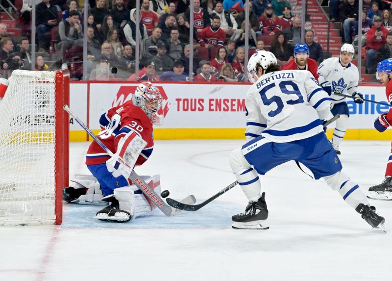 Apr 6, 2024; Montreal, Quebec, CAN; Montreal Canadiens goalie Cayden Primeau (30) stops Toronto Maple Leafs forward Tyler Bertuzzi (59) during the third period at the Bell Centre. Mandatory Credit: Eric Bolte-USA TODAY Sports