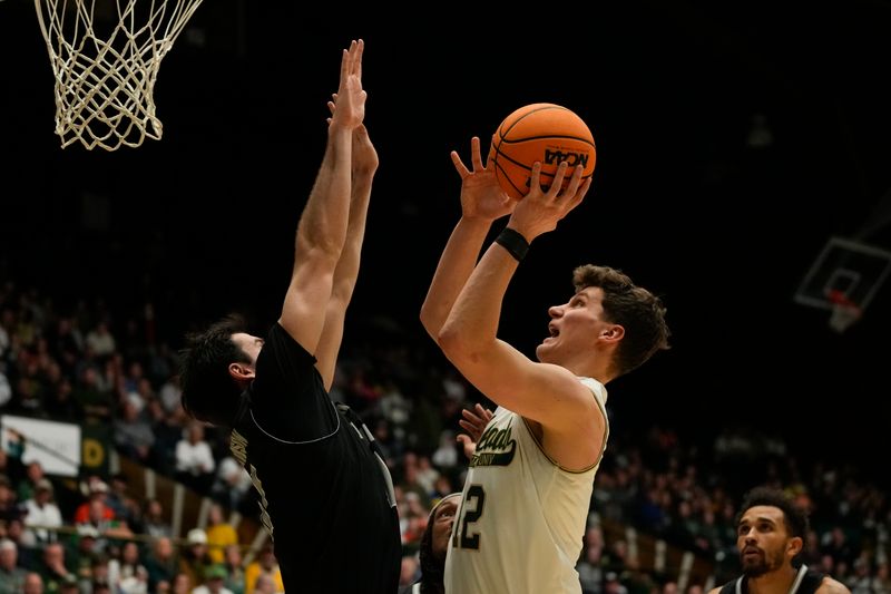 Feb 27, 2024; Fort Collins, Colorado, USA; Colorado State Rams forward Patrick Cartier (12) attempts a shot over Nevada Wolf Pack forward Nick Davidson (11) during the second half at Moby Arena. Mandatory Credit: Michael Madrid-USA TODAY Sports