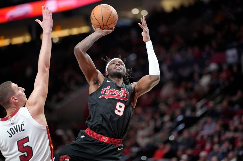 PORTLAND, OREGON - FEBRUARY 27: Jerami Grant #9 of the Portland Trail Blazers is fouled while shooting by Nikola Jovic #5 of the Miami Heat during the first half at Moda Center on February 27, 2024 in Portland, Oregon. NOTE TO USER: User expressly acknowledges and agrees that, by downloading and or using this photograph, User is consenting to the terms and conditions of the Getty Images License Agreement. (Photo by Soobum Im/Getty Images)