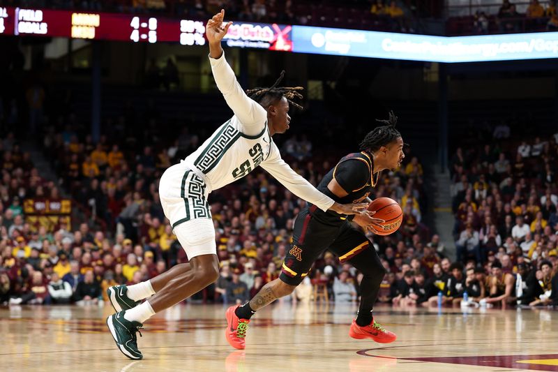 Feb 6, 2024; Minneapolis, Minnesota, USA; Minnesota Golden Gophers guard Elijah Hawkins (0) works around Michigan State Spartans forward Coen Carr (55) during the first half at Williams Arena. Mandatory Credit: Matt Krohn-USA TODAY Sports