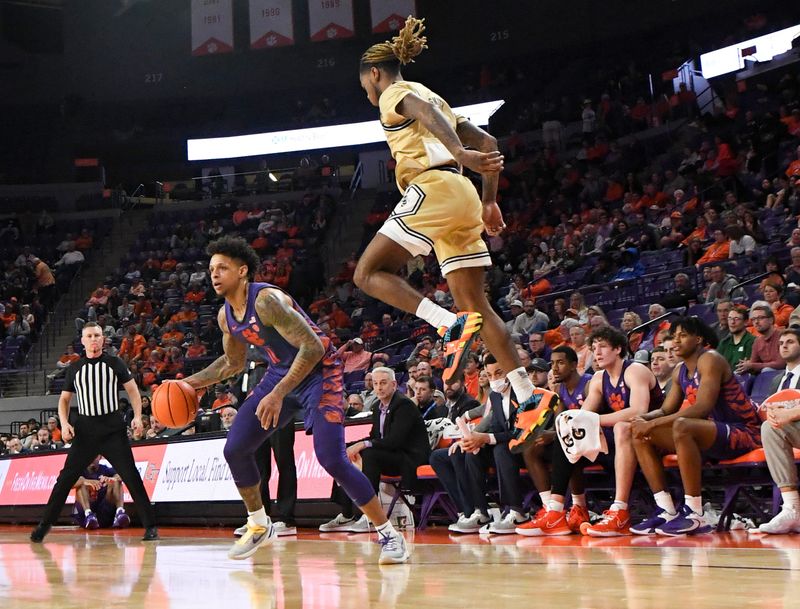 Jan 24, 2023; Clemson, South Carolina, USA; Clemson guard Brevin Galloway (11) steps to the side as Georgia Tech guard Deivon Smith (5) tries to defend him during the second half  at Littlejohn Coliseum. Mandatory Credit: Ken Ruinard-USA TODAY Sports