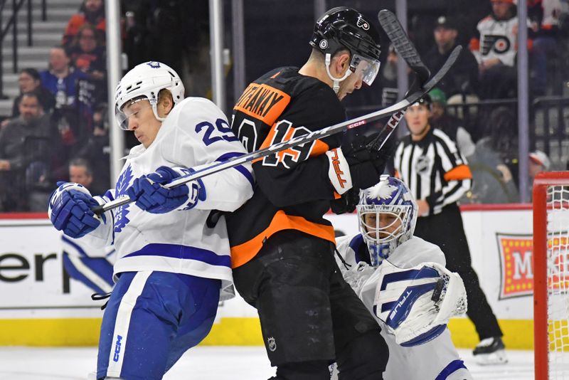 Mar 19, 2024; Philadelphia, Pennsylvania, USA; Toronto Maple Leafs goaltender Ilya Samsonov (35) makes a save as Philadelphia Flyers right wing Garnet Hathaway (19) and  right wing Pontus Holmberg (29) battle for position during the first period at Wells Fargo Center. Mandatory Credit: Eric Hartline-USA TODAY Sports