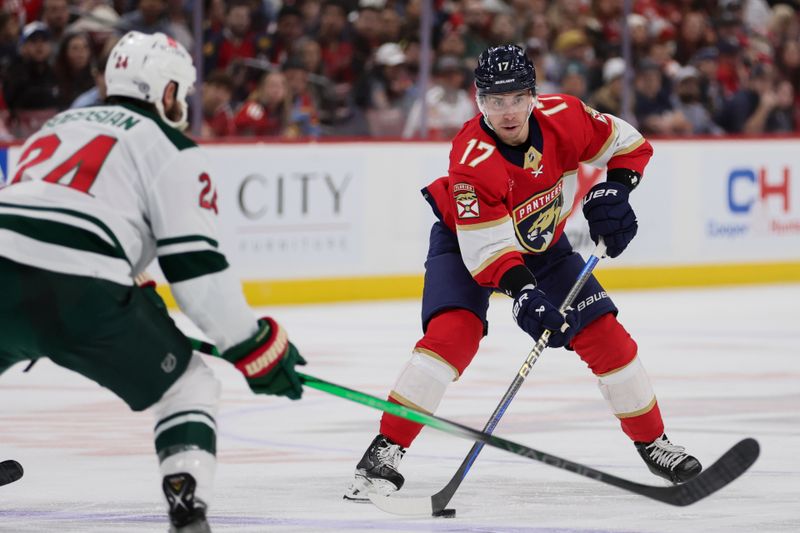 Jan 19, 2024; Sunrise, Florida, USA; Florida Panthers center Evan Rodrigues (17) moves the puck against the Minnesota Wild during the second period at Amerant Bank Arena. Mandatory Credit: Sam Navarro-USA TODAY Sports