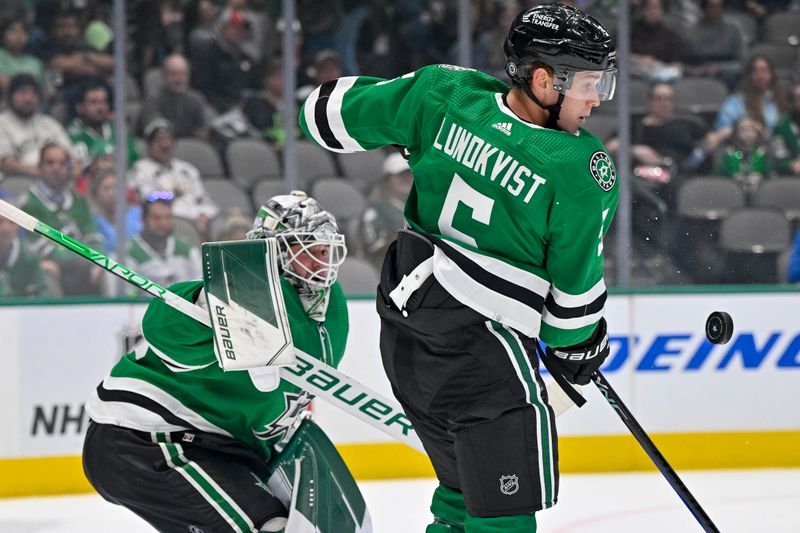 Oct 3, 2022; Dallas, Texas, USA; Dallas Stars defenseman Nils Lundkvist (5) blocks a Colorado Avalanche shot in front of Stars goaltender Jake Oettinger (29) during the first period at the American Airlines Center. Mandatory Credit: Jerome Miron-USA TODAY Sports