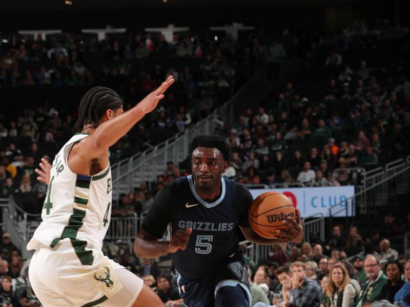 MILWAUKEE, WI - OCTOBER 20: Vince Williams Jr. #5 of the Memphis Grizzlies handles the ball during the preseason game on October 20, 2023 at the Fiserv Forum Center in Milwaukee, Wisconsin. NOTE TO USER: User expressly acknowledges and agrees that, by downloading and or using this Photograph, user is consenting to the terms and conditions of the Getty Images License Agreement. Mandatory Copyright Notice: Copyright 2023 NBAE (Photo by Gary Dineen/NBAE via Getty Images).