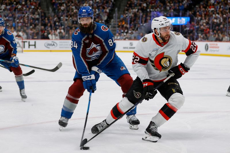 Jan 8, 2026; Denver, Colorado, USA; Ottawa Senators right wing Michael Amadio (22) controls the puck ahead of Colorado Avalanche defenseman Brent Burns (84) in the first period at Ball Arena. Mandatory Credit: Isaiah J. Downing-Imagn Images