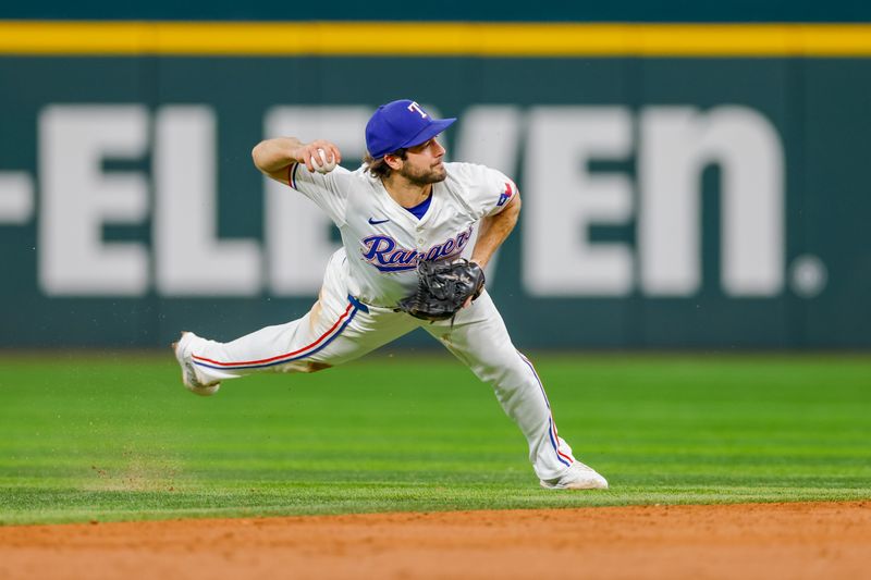 Sep 4, 2024; Arlington, Texas, USA; Texas Rangers shortstop Josh Smith (8) attempts to make a throw over to first base during the third inning against the New York Yankees at Globe Life Field. Mandatory Credit: Andrew Dieb-Imagn Images