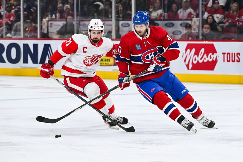 Dec 2, 2023; Montreal, Quebec, CAN; Montreal Canadiens right wing Joel Armia (40) plays the puck against Detroit Red Wings center Dylan Larkin (71) during the first period at Bell Centre. Mandatory Credit: David Kirouac-USA TODAY Sports