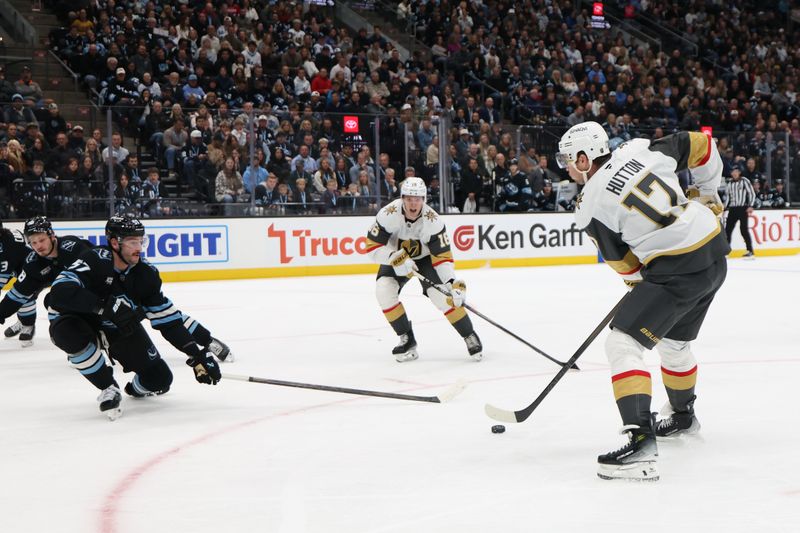Nov 24, 2025; Salt Lake City, Utah, USA; Vegas Golden Knights defenseman Ben Hutton (17) passes to right wing Pavel Dorofeyev (16) against Utah Mammoth defenseman Nick Desimone (57) during the first period at Delta Center. Mandatory Credit: Rob Gray-Imagn Images