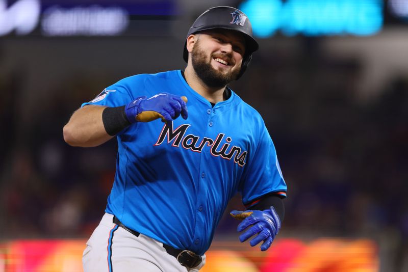 Jul 21, 2024; Miami, Florida, USA; Miami Marlins third baseman Jake Burger (36) reacts as he runs past third base after hitting a home run against the New York Mets during the seventh inning at loanDepot Park. Mandatory Credit: Sam Navarro-USA TODAY Sports