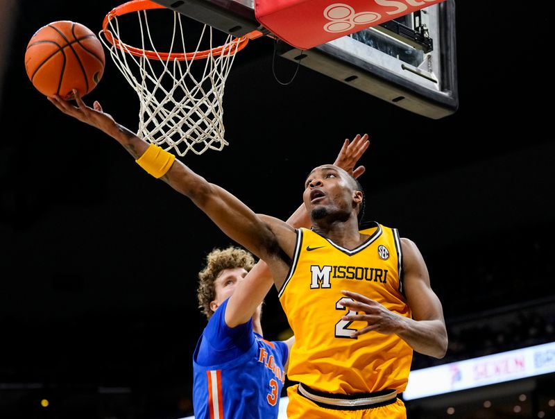 Jan 20, 2024; Columbia, Missouri, USA; Missouri Tigers guard Tamar Bates (2) shoots against Florida Gators center Micah Handlogten (3) during the first half at Mizzou Arena. Mandatory Credit: Jay Biggerstaff-USA TODAY Sports