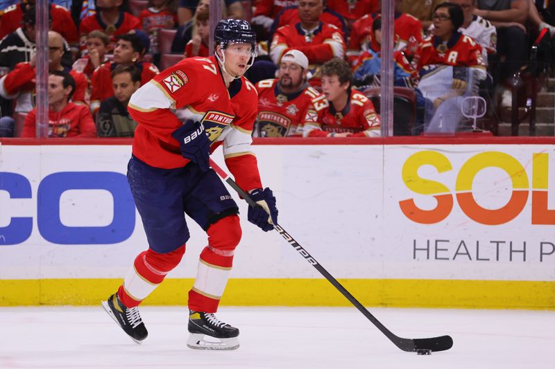 Apr 9, 2024; Sunrise, Florida, USA; Florida Panthers defenseman Niko Mikkola (77) moves the puck against the Ottawa Senators during the second period at Amerant Bank Arena. Mandatory Credit: Sam Navarro-USA TODAY Sports