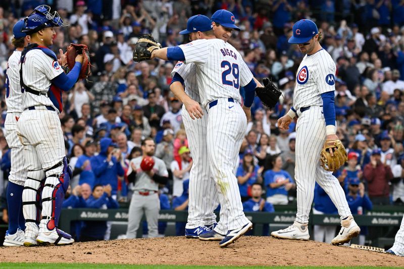 Sep 28, 2024; Chicago, Illinois, USA;  Chicago Cubs pitcher Kyle Hendricks (28) hugs first baseman Michael Busch (29) after he was pulled from the game during the  eighth inning against the Cincinnati Reds at Wrigley Field. Mandatory Credit: Matt Marton-Imagn Images