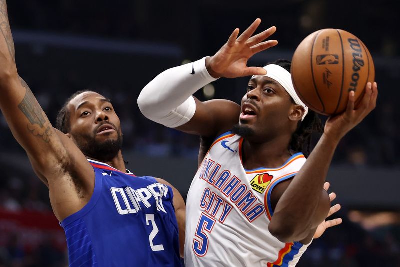 LOS ANGELES, CALIFORNIA - JANUARY 16: Luguentz Dort #5 of the Oklahoma City Thunder drives past Kawhi Leonard #2 of the Los Angeles Clippers during the third quarter at Crypto.com Arena on January 16, 2024 in Los Angeles, California. NOTE TO USER: User expressly acknowledges and agrees that, by downloading and or using this photograph, User is consenting to the terms and conditions of the Getty Images License Agreement. (Photo by Katelyn Mulcahy/Getty Images)