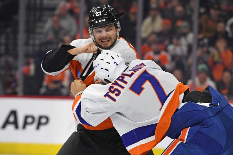 Jan 30, 2025; Philadelphia, Pennsylvania, USA; Philadelphia Flyers center Scott Laughton (21) fights with New York Islanders right wing Maxim Tsyplakov (7) during the first period at Wells Fargo Center. Mandatory Credit: Eric Hartline-Imagn Images