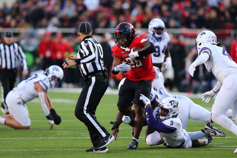 Nov 2, 2023; Lubbock, Texas, USA; Texas Tech Red Raiders running back Tahj Brooks (28) rushes against Texas Christian Horned Frogs defensive safety Mark Perry (3) in the first half at Jones AT&T Stadium and Cody Campbell Field. Mandatory Credit: Michael C. Johnson-USA TODAY Sports