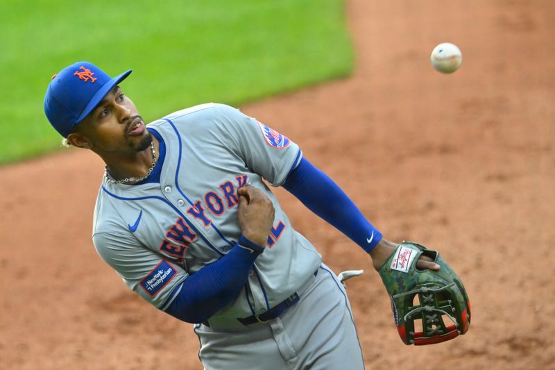 May 20, 2024; Cleveland, Ohio, USA; New York Mets shortstop Francisco Lindor (12) tosses a ball to the stands in the fourth inning against the Cleveland Guardians at Progressive Field. Mandatory Credit: David Richard-USA TODAY Sports