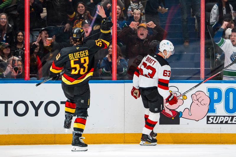 Jan 23, 2026; Vancouver, British Columbia, CAN; New Jersey Devils forward Jesper Bratt (63) reacts as Vancouver Canucks forward Teddy Blueger (53) celebrates his goal in the second period at Rogers Arena. Mandatory Credit: Bob Frid-Imagn Images