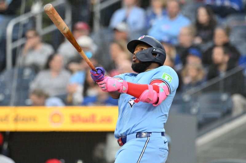 Aug 19, 2024; Toronto, Ontario, CAN; Toronto Blue Jays designated hitter Vladimir Guerrero Jr. (27) hits a solo home run against the Cincinnati Reds in the first inning at Rogers Centre. Mandatory Credit: Dan Hamilton-USA TODAY Sports