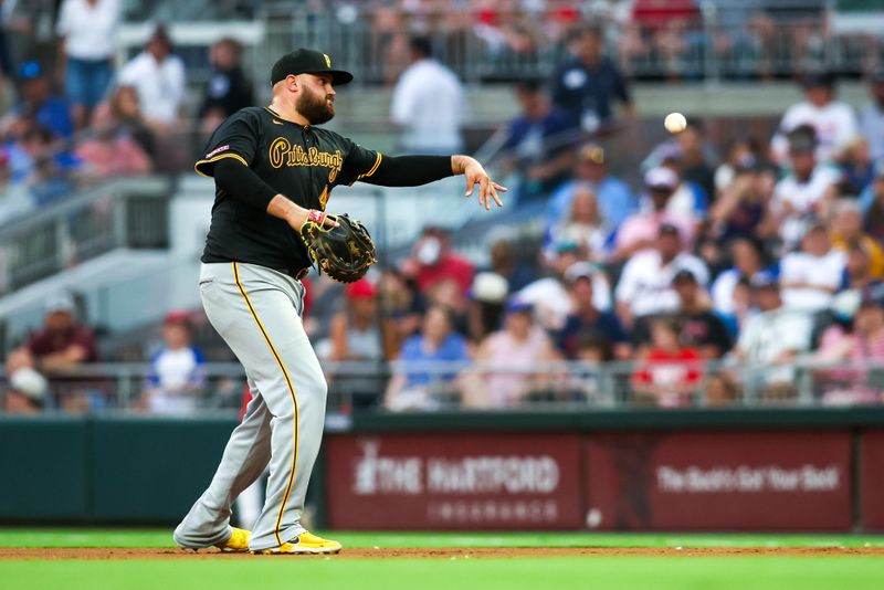 Jun 28, 2024; Atlanta, Georgia, USA; Pittsburgh Pirates first baseman Rowdy Tellez (44) throws a runner out at first against the Atlanta Braves in the fourth inning at Truist Park. Mandatory Credit: Brett Davis-USA TODAY Sports